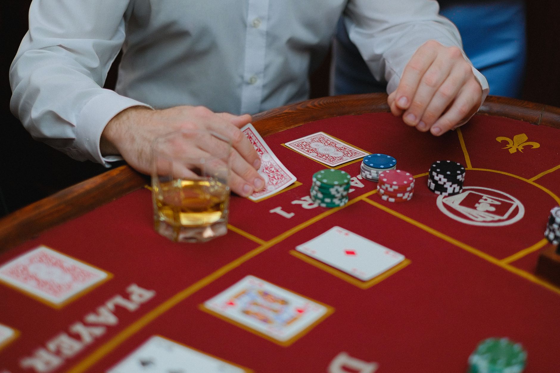 Intense poker game with cards and chips on a red casino table, creating a thrilling atmosphere. — 5 Benefits of using ufabet