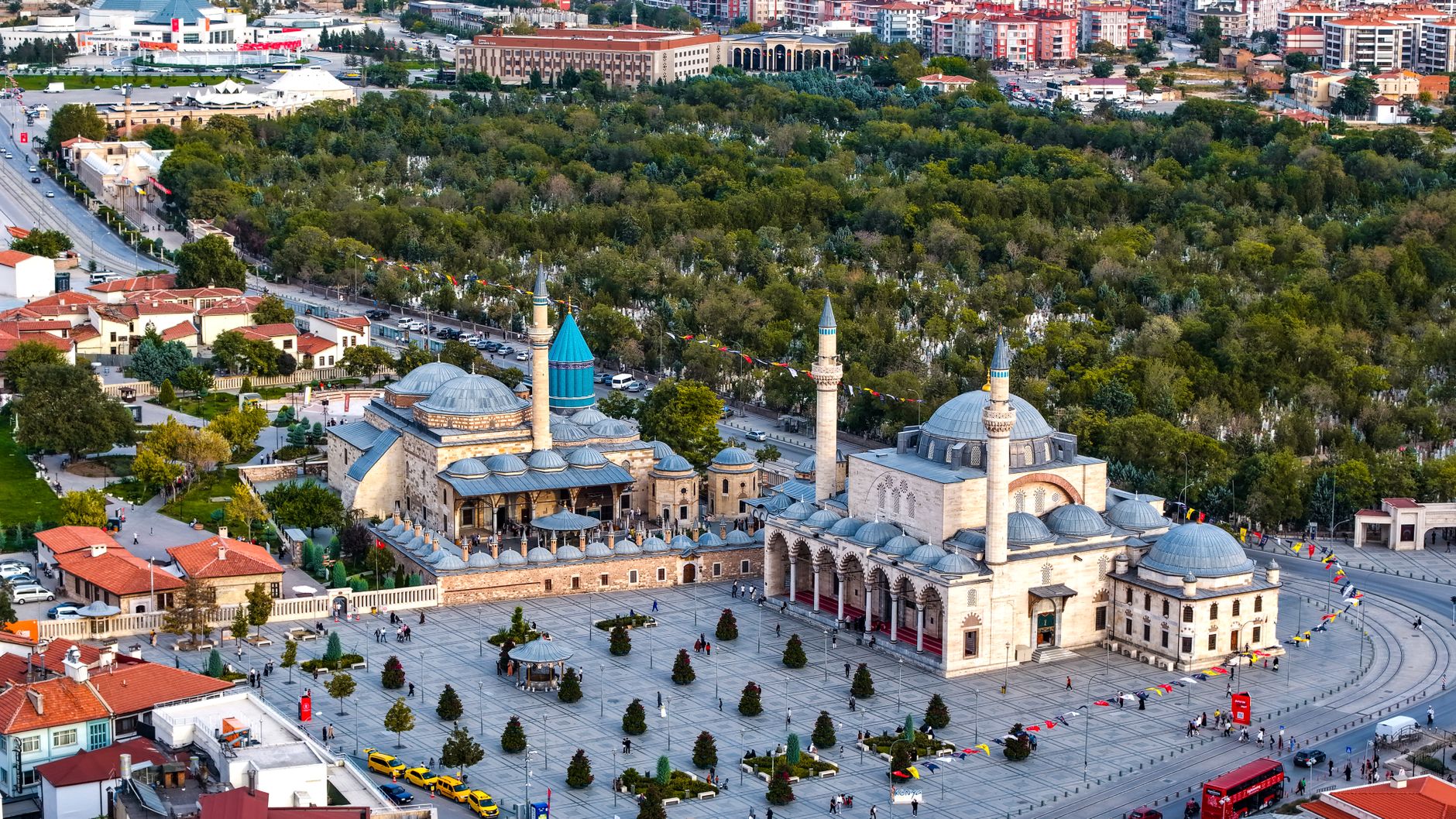 Vibrant aerial view of the iconic Mevlana Museum located in Konya, Türkiye, surrounded by lush greenery. — Baccarat Brings th