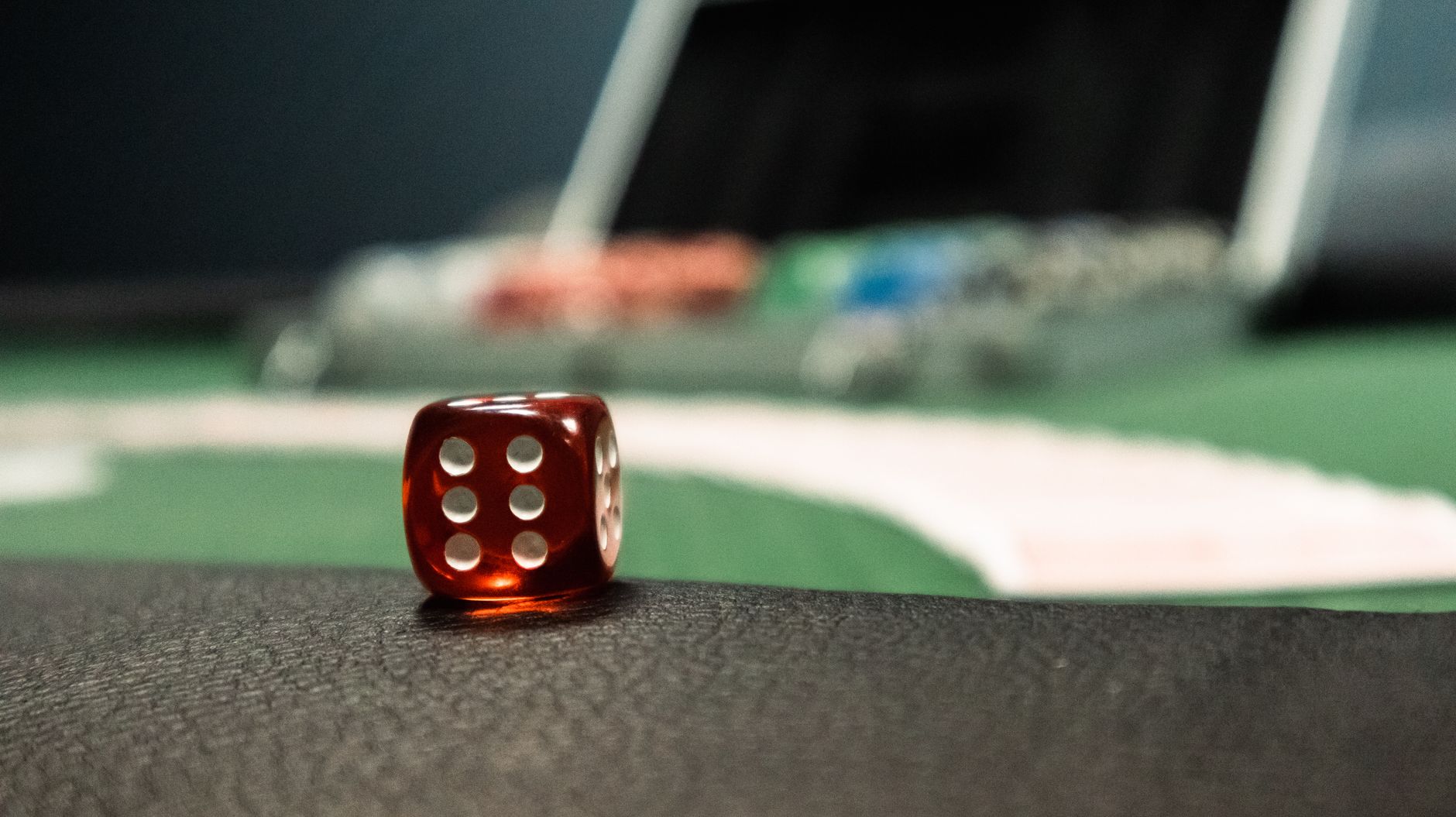 A close-up of a red dice on a casino table, evoking a sense of gambling excitement. — Baccarat Strategies That Actually Work