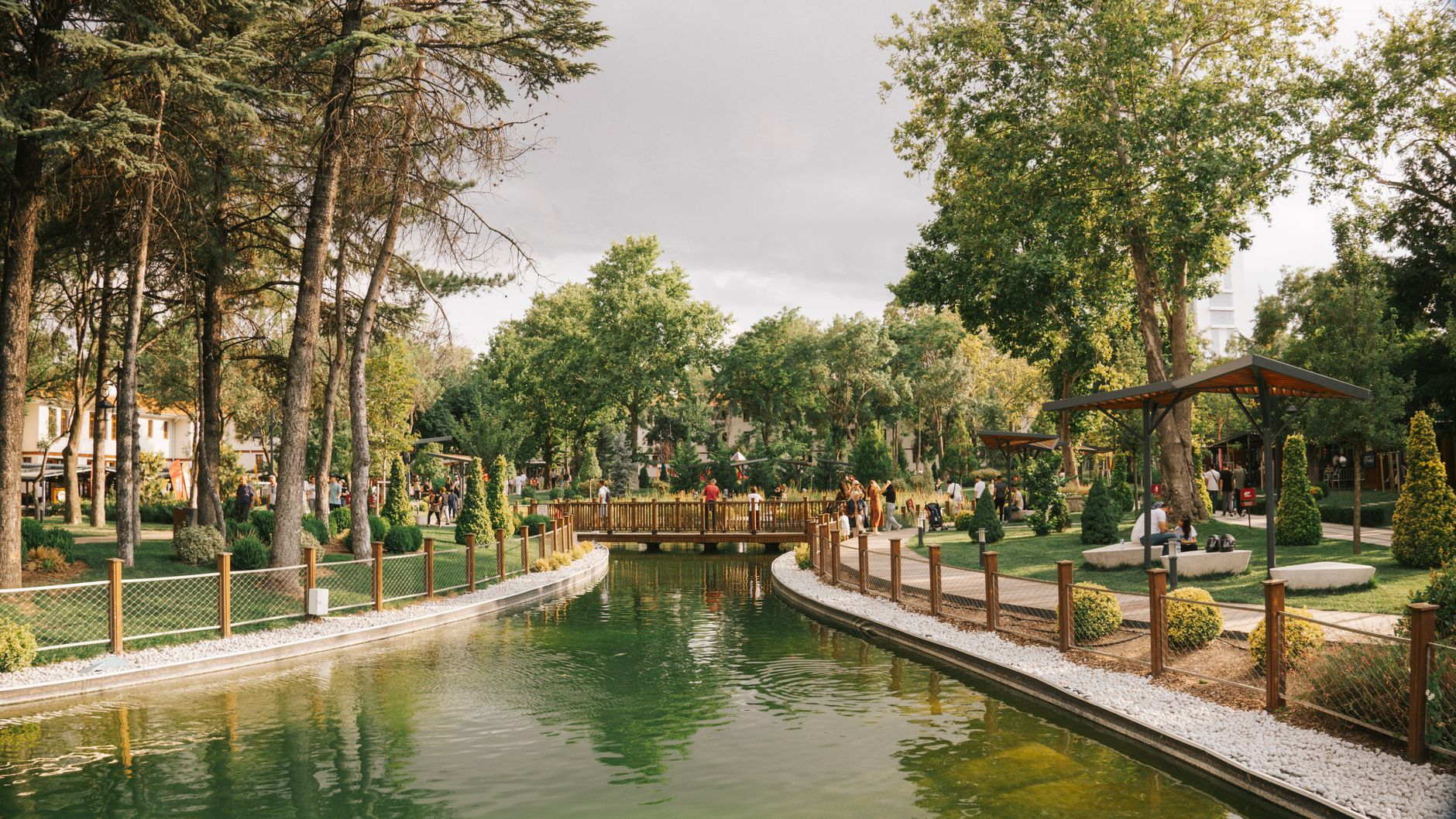 Peaceful park scene featuring a serene pond, a wooden bridge, and lush greenery. — Casino News: Keep up with all the latest c