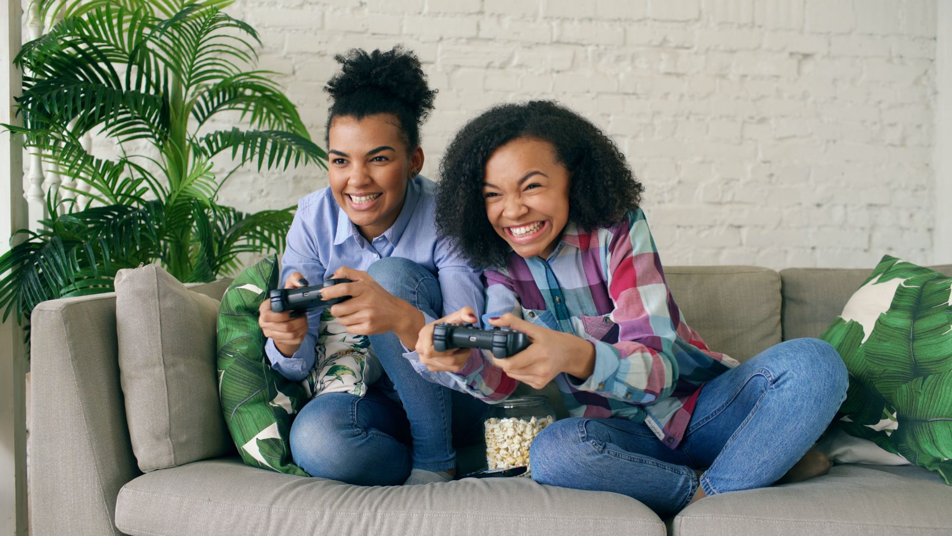 Two teenagers enjoying video games on a couch, showing excitement and joy. — Everything You Wanted to Know About Online Casin