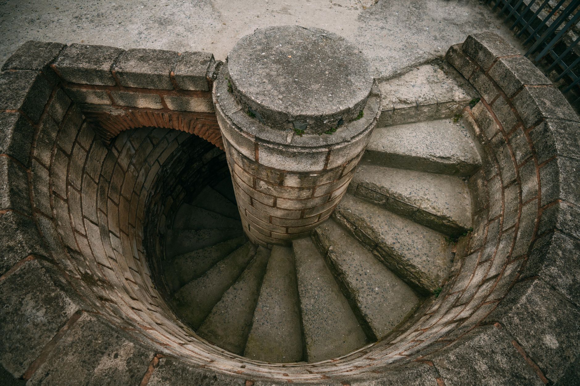 Top view of a spiraling stone staircase outdoors, showcasing architectural beauty. — Hello world!