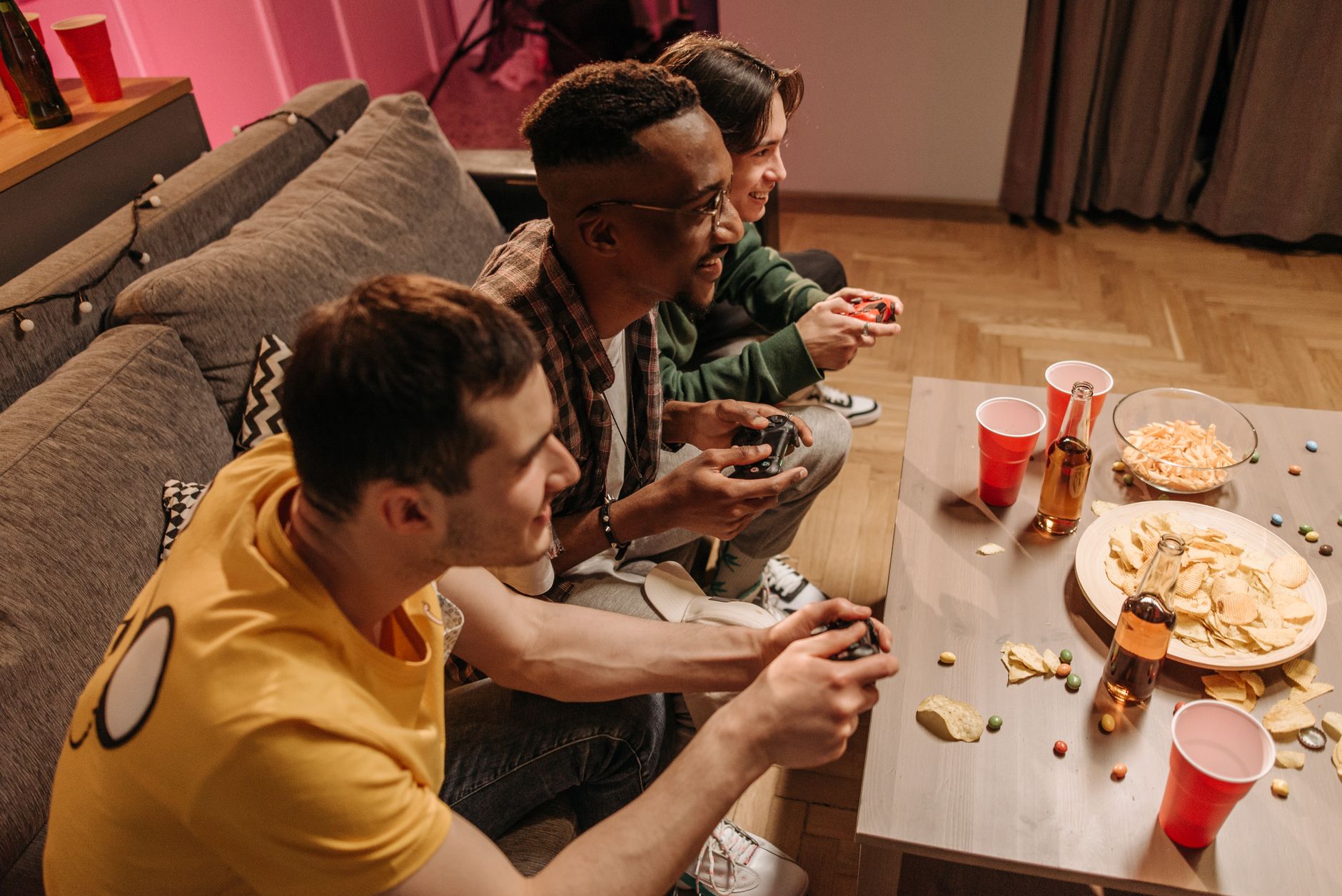 Group of friends playing video games and enjoying snacks indoors. — How To Get Better Odds In fun88