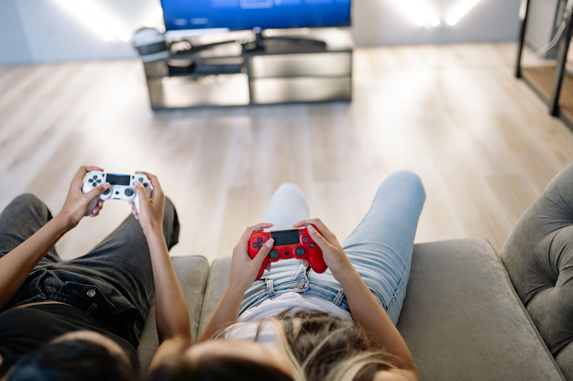 Two friends playing video games together indoors with game controllers. — How To Play Online Baccarat And Make Money!