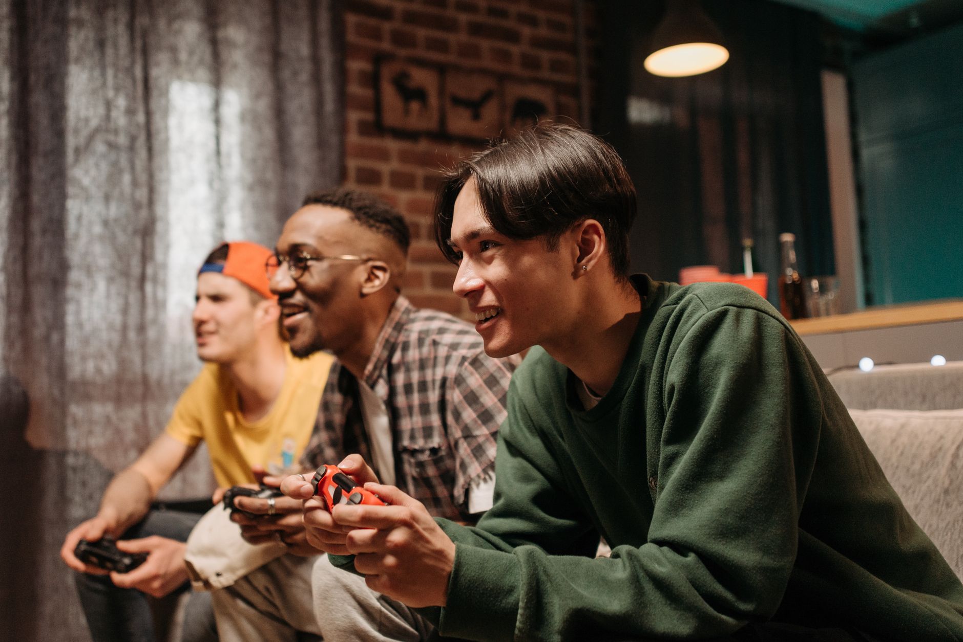 Diverse group of young adults enjoying video games together indoors, creating a fun and social atmosphere. — Live Casino Manu