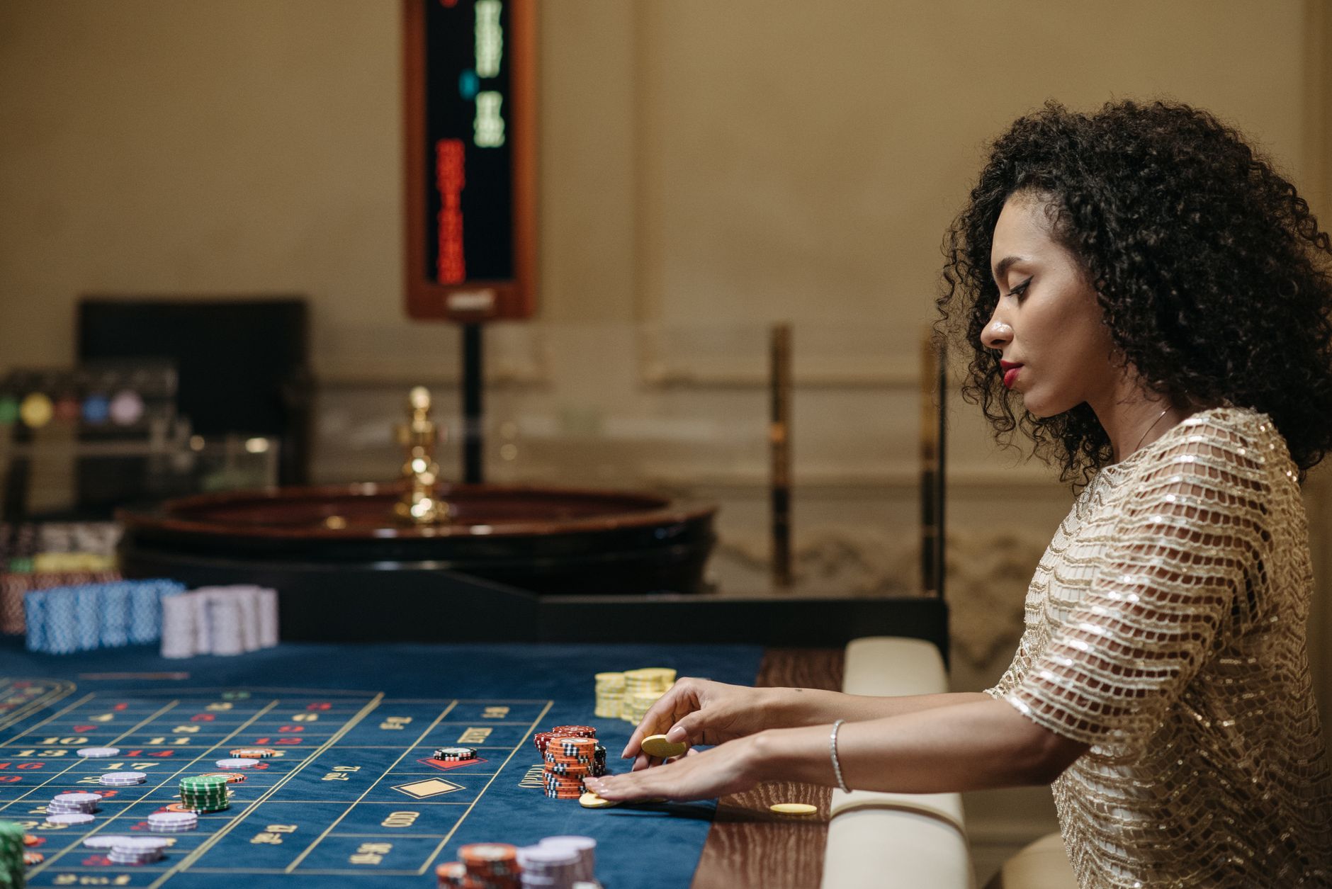 Stylish woman in a casino setting, playing roulette with stacks of chips. — Things You Need To Do To Have An Amazing
