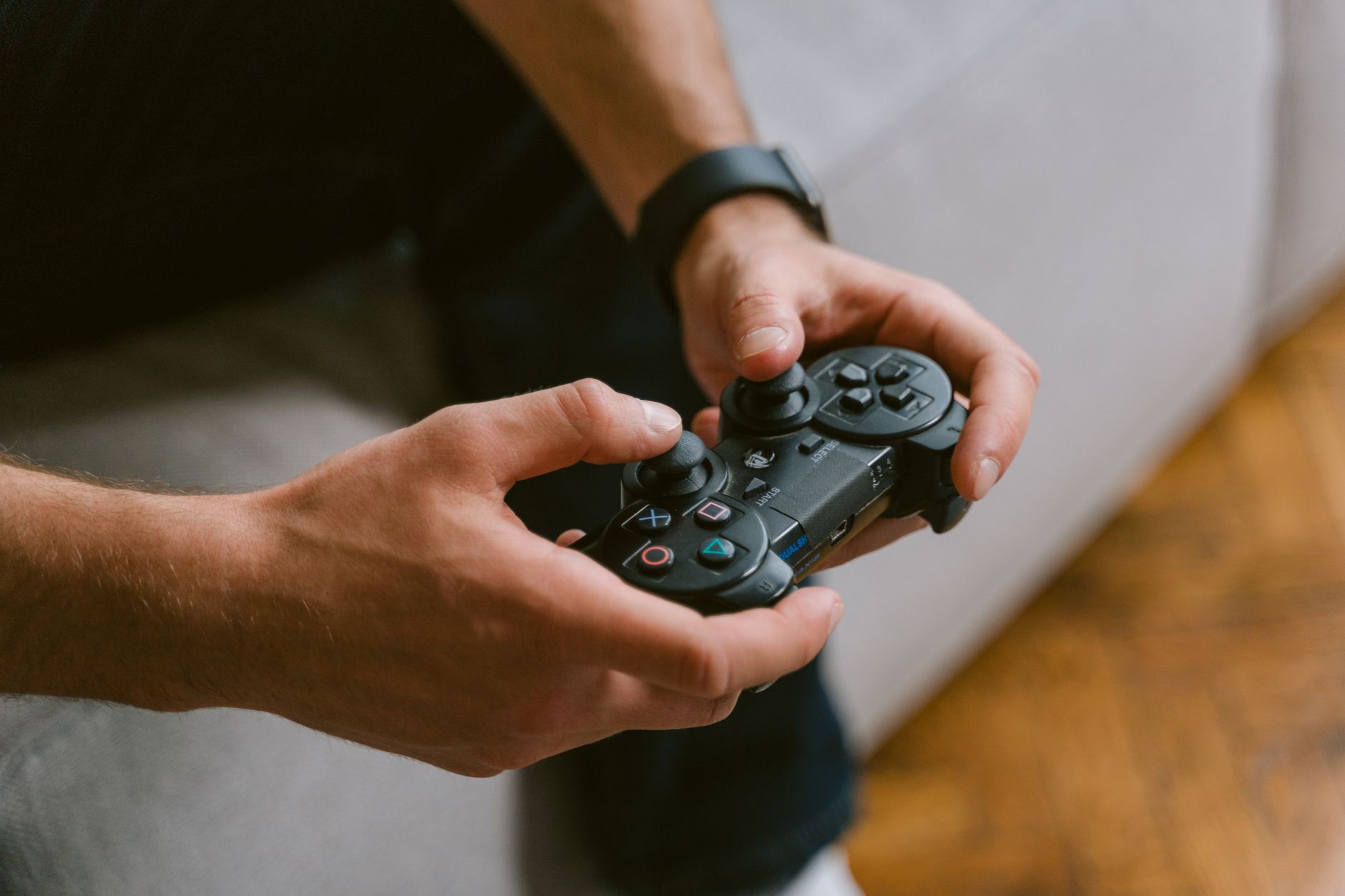 Hands holding a game controller while playing video games indoors, a leisure activity. — Tips For Maximizing Your Win