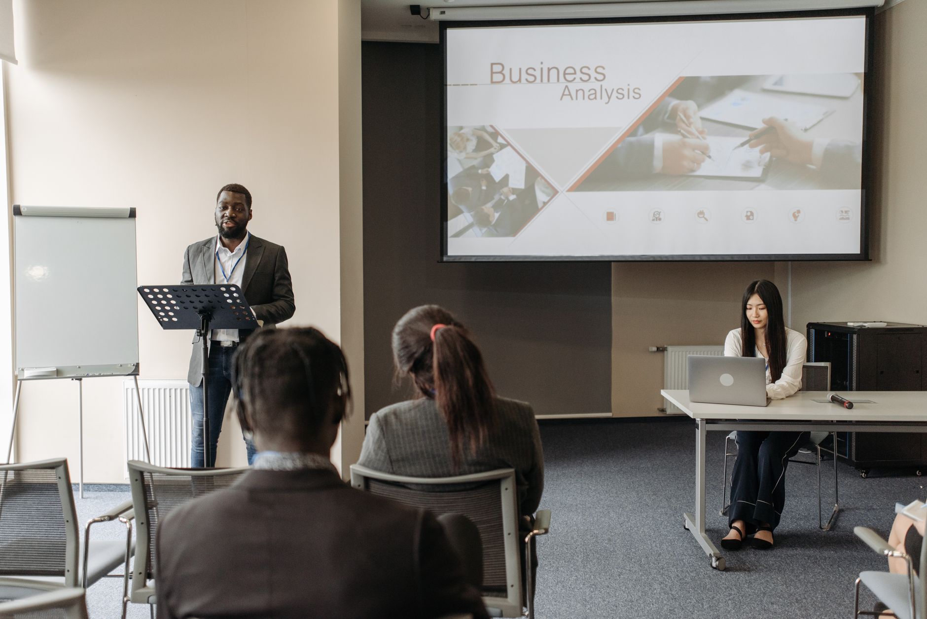 Business seminar with a speaker and audience in a conference room. — Winning with Confidence: How Sports Bettors Can