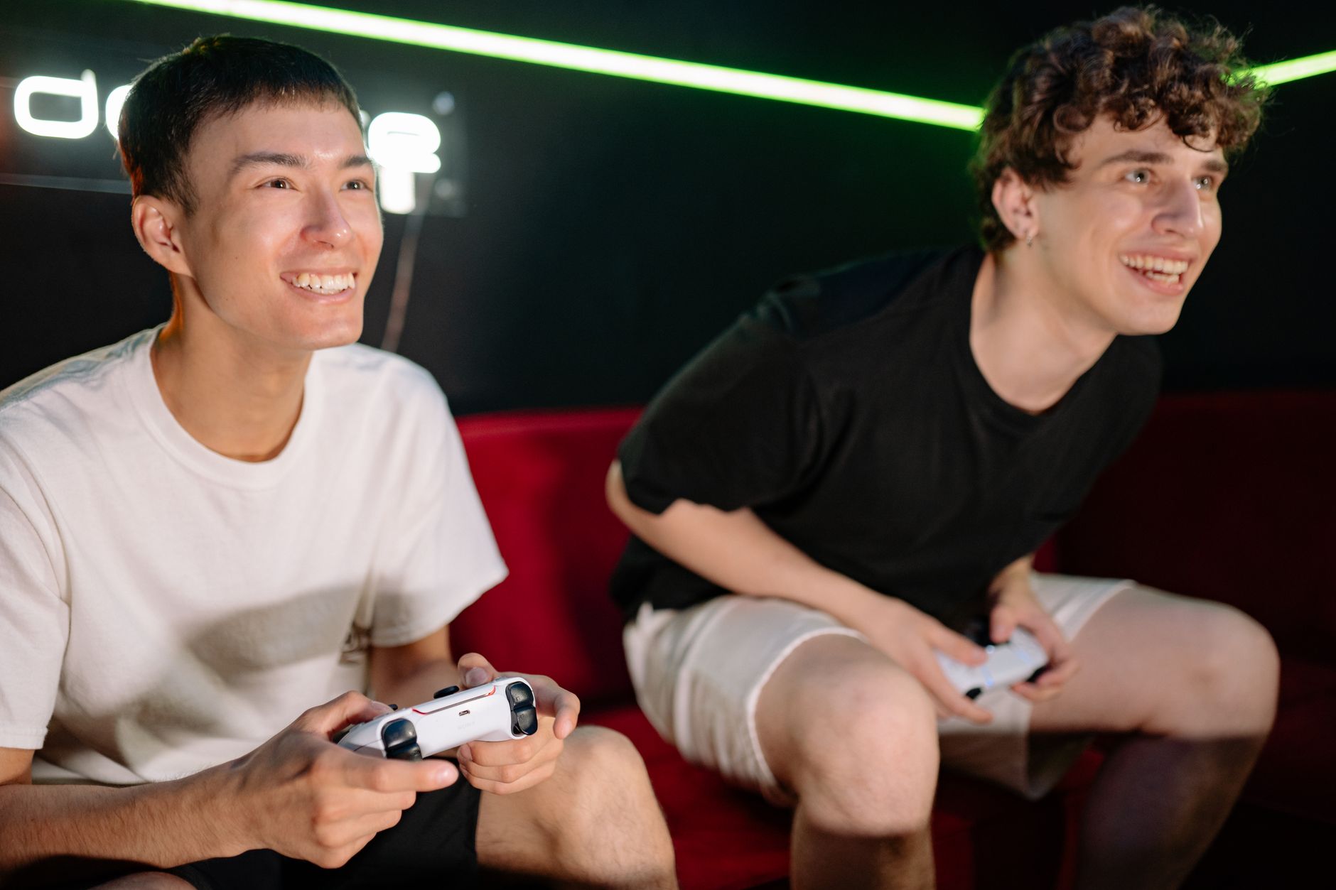 Two friends having fun playing video games indoors, captured in a lively and engaging moment. — The Best Things About Betting