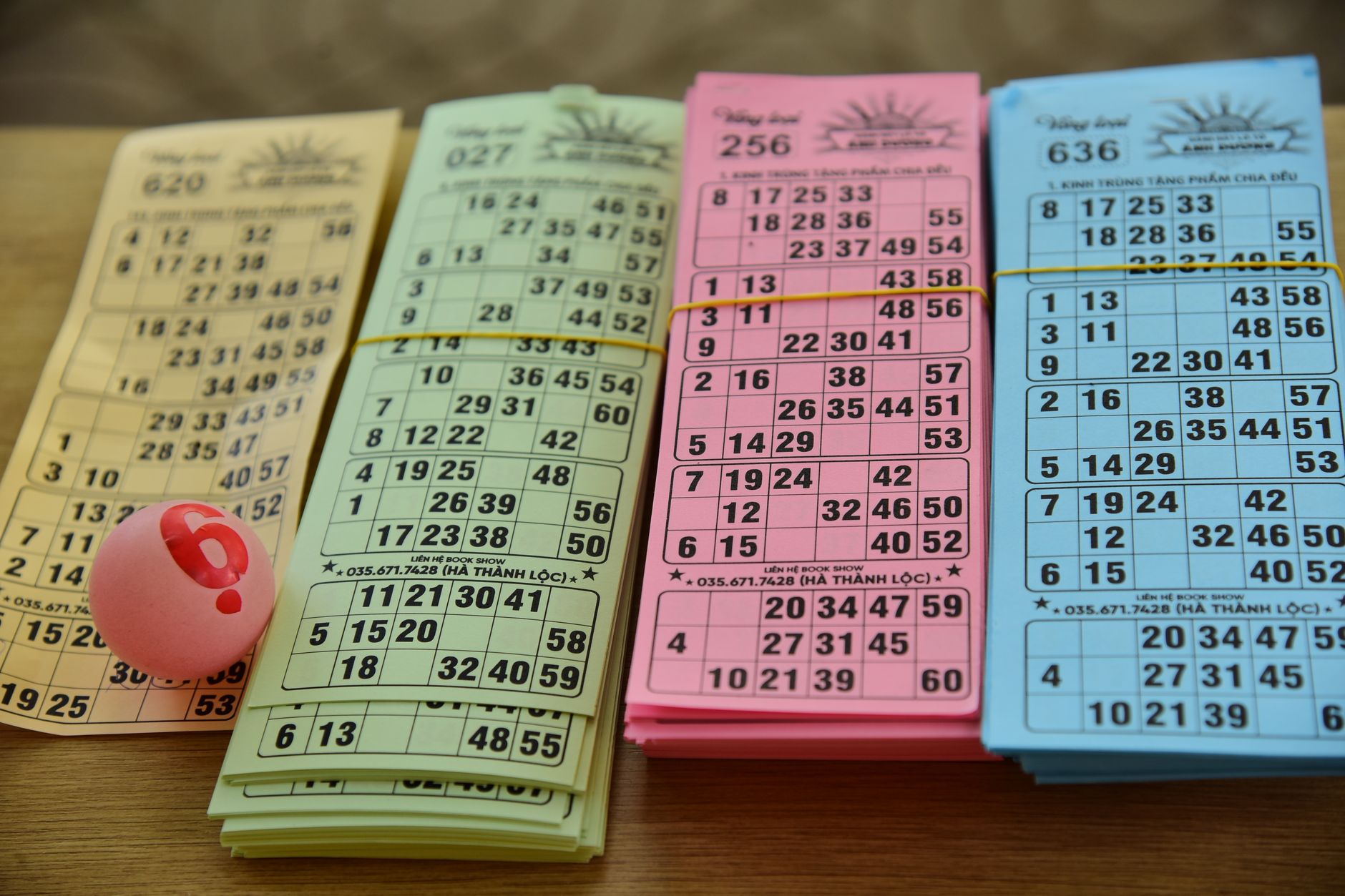 A set of colorful bingo cards and a numbered ball on a table, ready for a game night. — The Good, Bad, and Ugly of Playing th