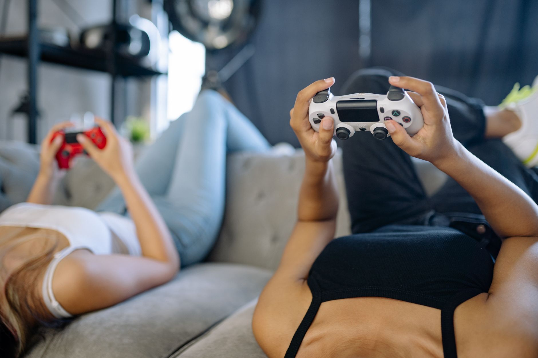 Two women relaxing and playing video games on a couch in a cozy living room. — The Power of Prediction: Winning Strategies fo