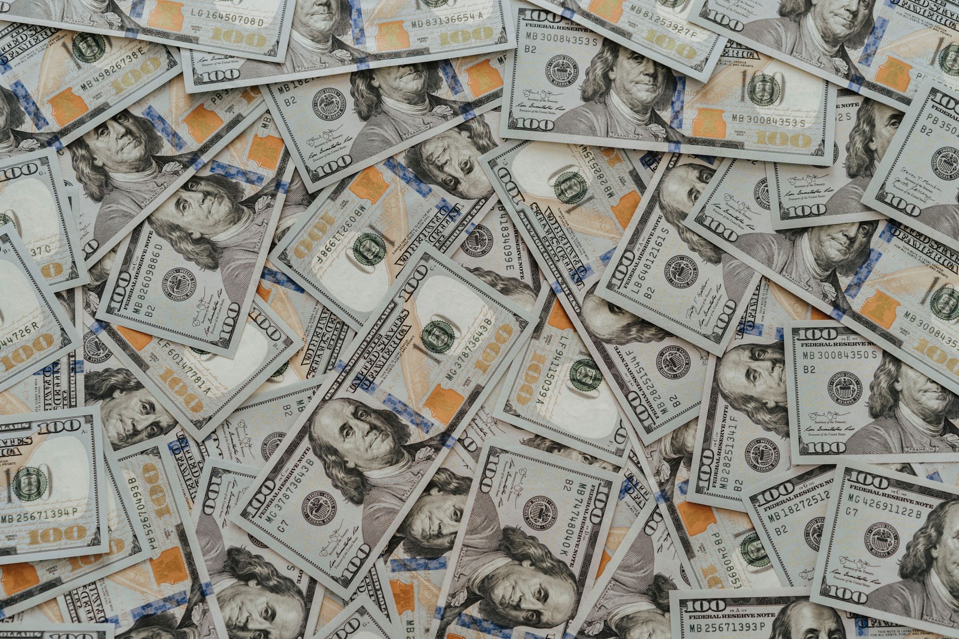 US hundred dollar bills scattered in abundance creating a financial backdrop. — UFABET - Play Online Football Sports Betting