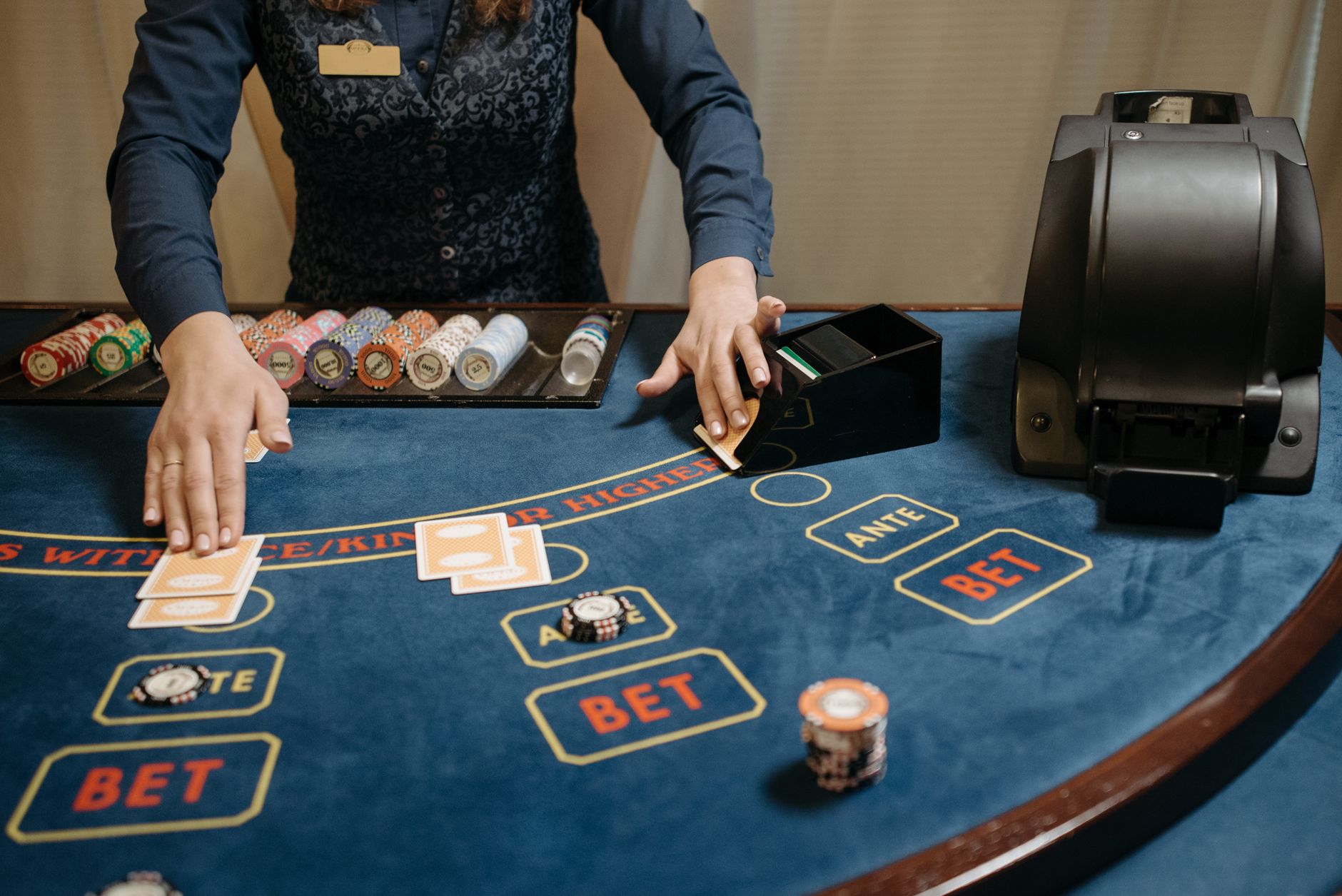 Casino dealer organizing cards and chips on a gaming table during a game. — UFABET- Provides You With The Chance To Create Re