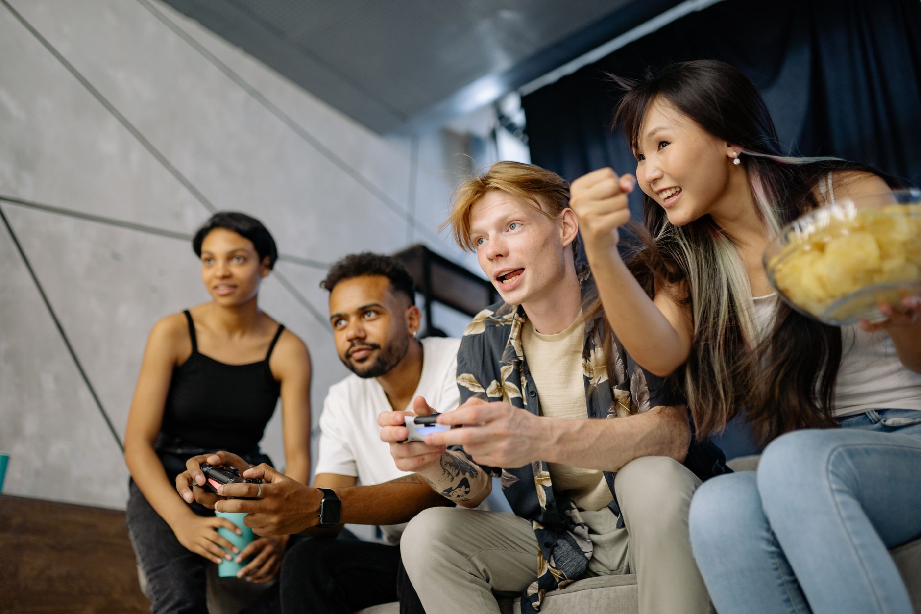 Four friends gaming enthusiastically inside a modern home, enjoying a lively moment. — What are the best casinos for gambling