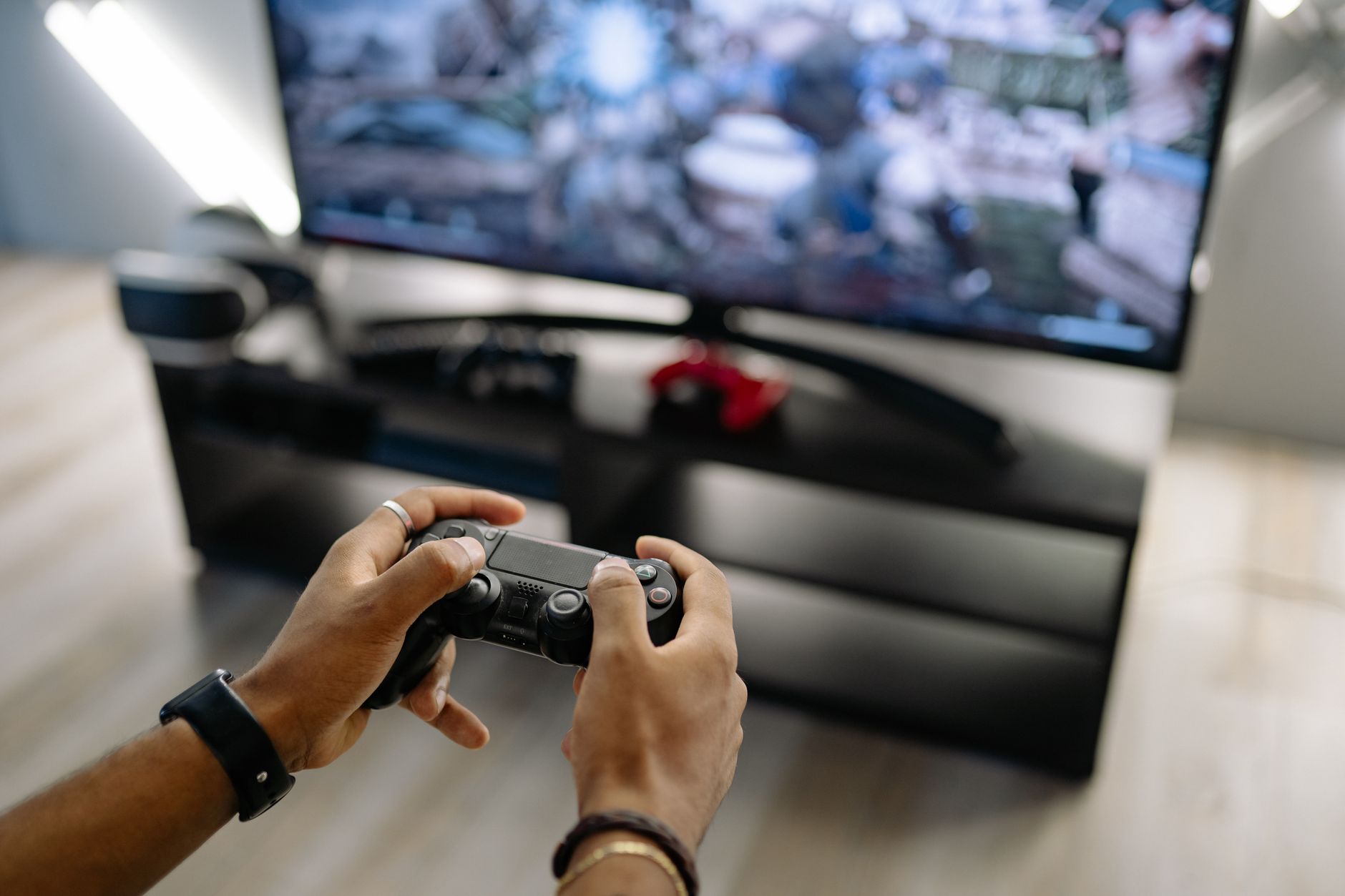 Close-up of hands holding a gaming controller while playing video games indoors. — What are the greatest online casinos where