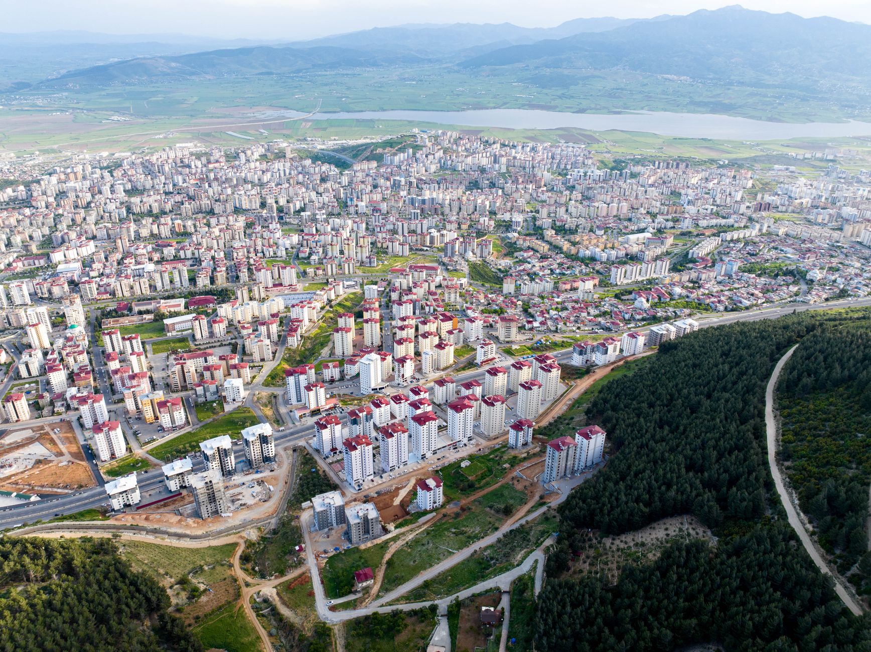 Aerial view showcasing the urban expansion and landscape of a vibrant city surrounded by nature. — What Does It Take To Be In